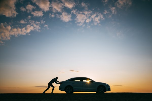 extended car warranty car breakdown guy pushing car sunset outdoor nature background